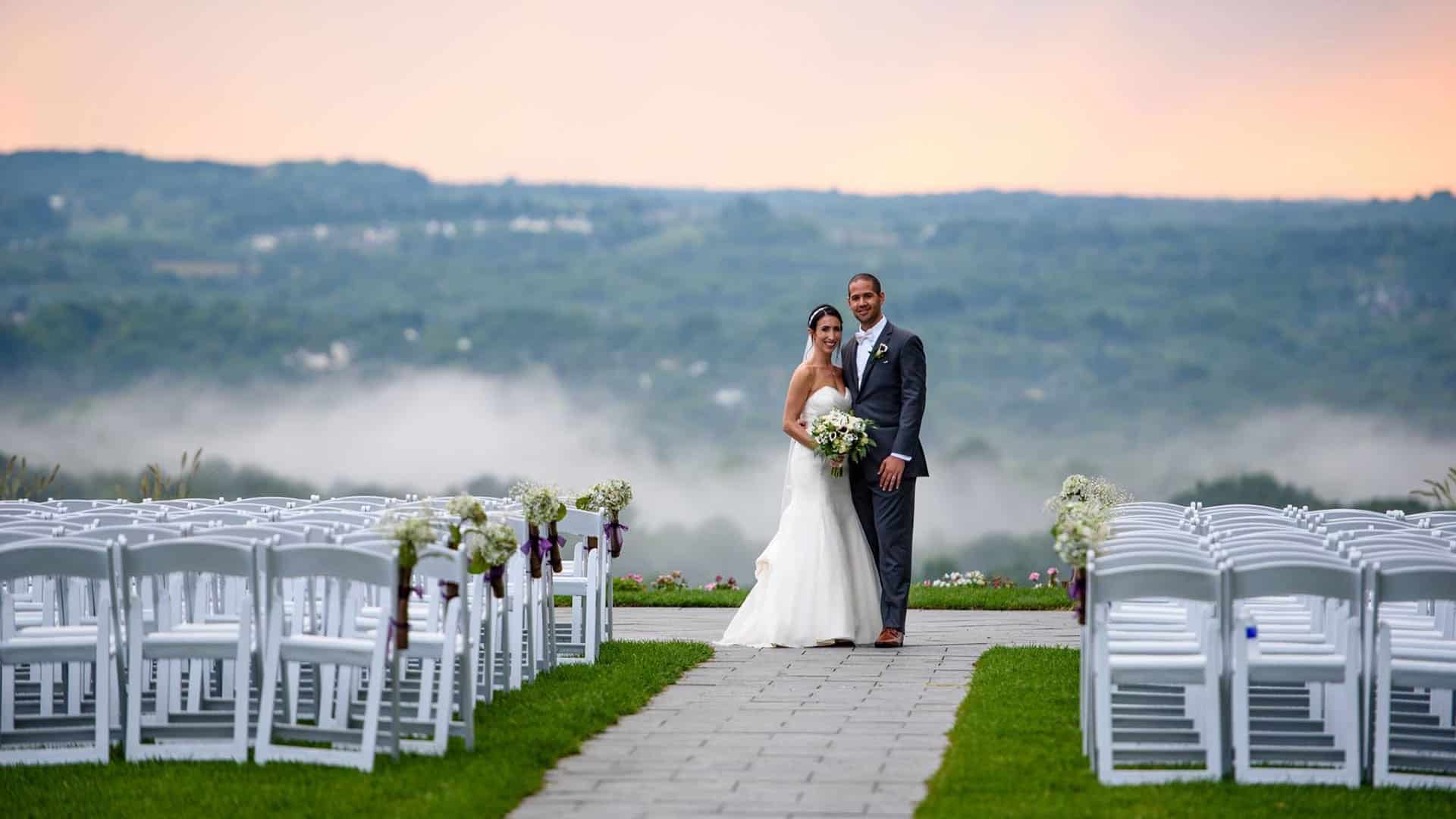 wedding_venue_rochester_ny_finger_lakes a bride and groom standing in front of rows of white chairs
