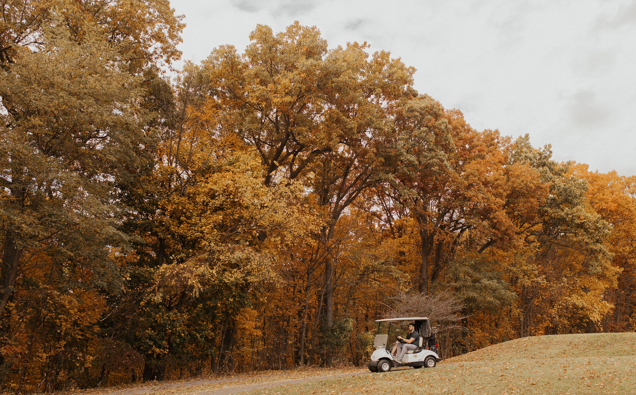 The Links at Woodcliff in fall Golf cart on The Links at Woodcliff beneath fall foliage