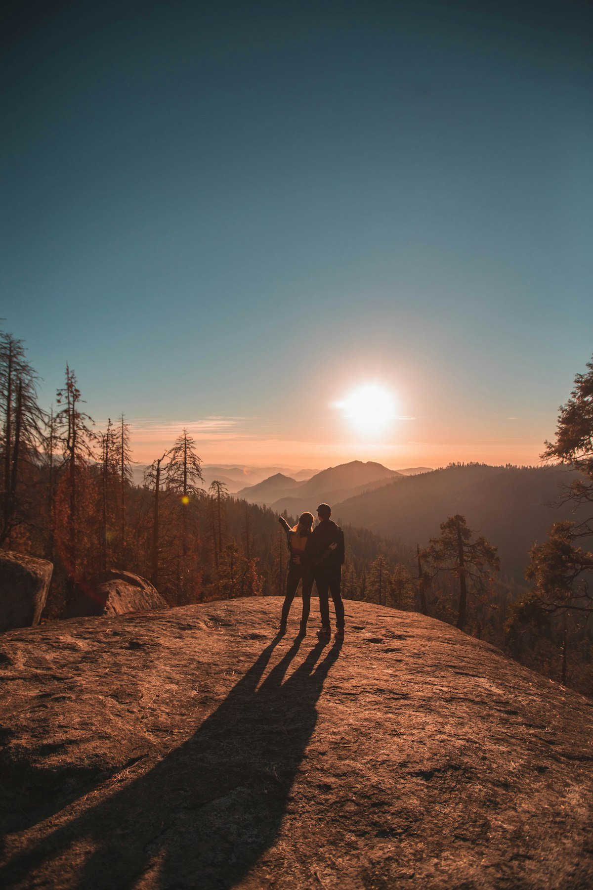 romance-ridge-fall-sunset-placeholder Couple silhouetted on a hilltop at sunset in autumn